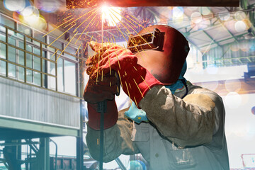 Industrial worker in factory welding process TIG with gas argon, light spark from working light...