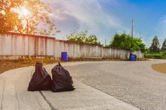 Two Garbage bag on road surface.
