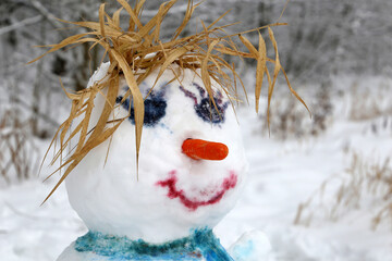 Funny snowman in a winter park. Children's creativity, leisure at cold weather