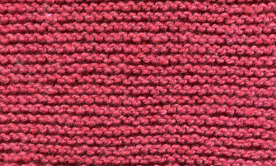 texture of a knitted red fabric with a simple pattern, horizontal rows