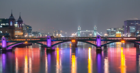 Fototapeta na wymiar Panoramic view over the famous historical London Bridge, River Thames and the Towers of London, illuminated at night