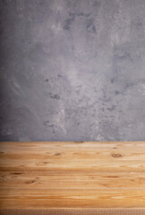 wooden desk table or shelf near grey concrete wall