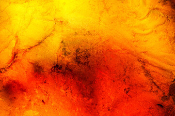 Amber macrophotography abstract background, dark black inclusion, colorful yellow orange and red. unpolished specimen
