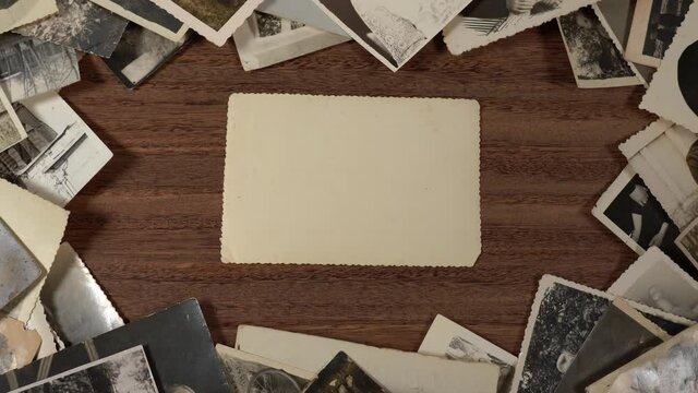 Frame made with many black and white old photos isolated on brown wooden tabel or floor background