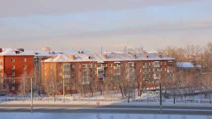 Fototapeta na wymiar House with renovated roof. Winter city landscape.