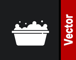 White Baby bathtub with foam bubbles inside icon isolated on black background. Vector.