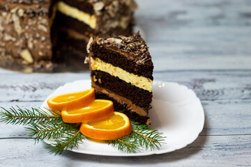 cake on a plate with orange chocolate filling on a light wooden background - Powered by Adobe