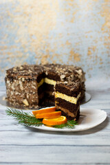 cake on a plate with orange chocolate filling on a light wooden background
