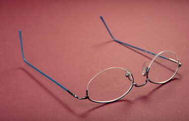 New metal glasses frame on a red background