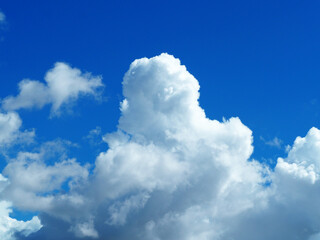 White clouds floating in the sky And has a blue background.