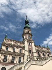 Poland Zamosc old town Great Market Square beautiful building Town Hall Ratusz. Building towering over the surrounding landscape. Zamosc is unique example of Renaissance to  Europe.