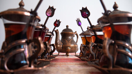 Turkish teacups with spoons and teapot.