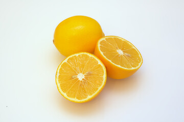 whole and split lemons on a white