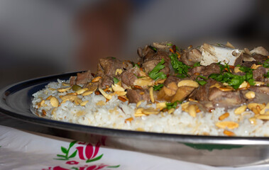 camel meat with rice traditional Arab food main course restaurant lunch served with almonds and pine seeds. 