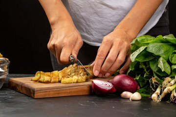 Cooking process, woman cut baked eggplant