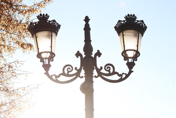Fototapeta na wymiar Wrought iron street lantern against the sky