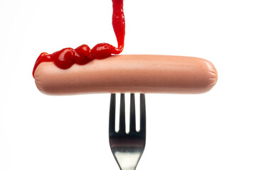 Sausage on fork on white background
