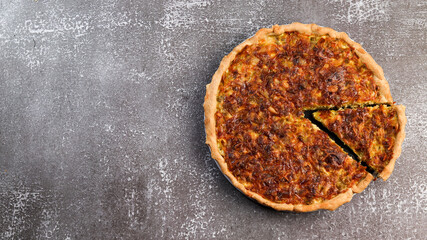 Leek pie with cheese on a dark background. Top view, flat lay