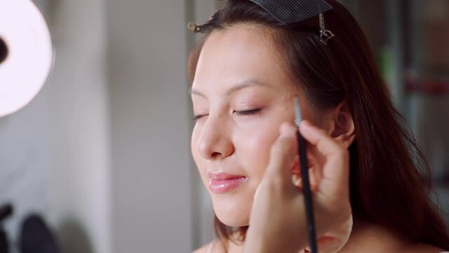 Happy attractive asian woman apply skincare cream on face and body.Female  hand touch face  and smooth applying cream and lotion for rejuvenation, beauty perfect with wellness, skin care .