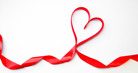 Red heart ribbon on a white background with place for a text. St Valentine's day concept. Expression of love. Romantic concept. Place for text