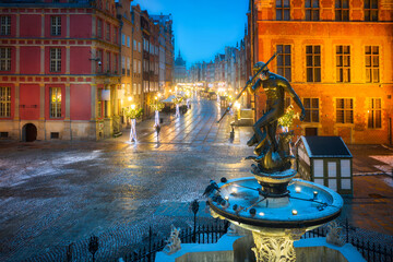Neptune Fountain and a Christmas decorations in snowy old town of Gdańsk. Poland