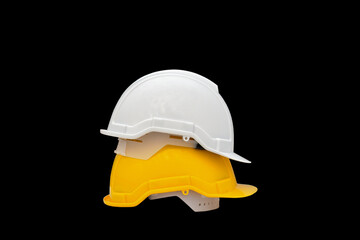 white and Yellow hard safety helmet on Black background, for safety first concept.