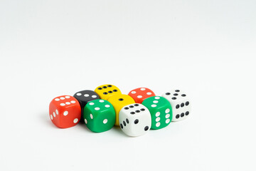 Mixed color standard size dice stacked together isolated on white background