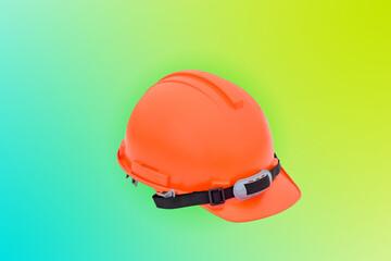 Safety hard helmet Orange color front side view isolated on bluel background, fore safety concept.