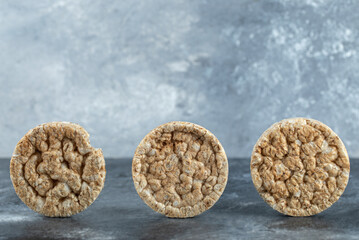 Delicious round crispbread on marble background