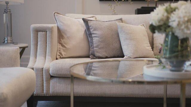 dolly shot of close up sofa beige color fabric pillow cushions luxury home interior decoration concept