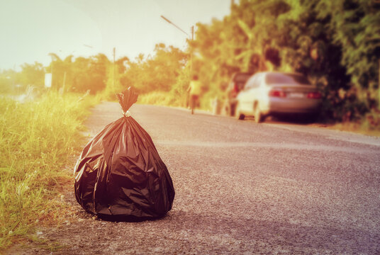 Retro filter tone of Pile of black garbage bag on footpath at side rode in city pollution trash.