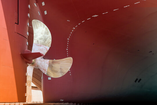 industry shipyard, Close up Rudder with Propeller at stern of big ship during maintenance at floating dry dock Thailand