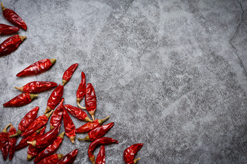 Red chilli peppers on stone background. Side border from top view. Empty space for text.	