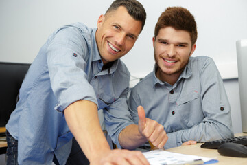 happy businessmen working on computer in office