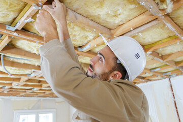 builder working on wood scaffolding in construction site