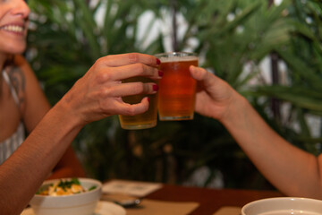 Girls toasting with beer in a restaurant
