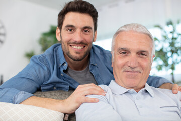 cheerful 60s father embrace grown up son