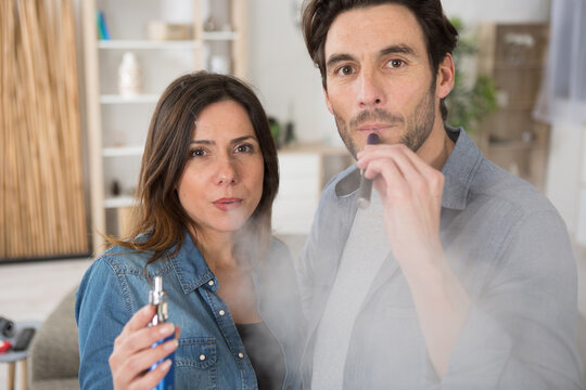 picture of couple vape smoking in the house