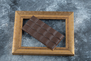 Bar of dark chocolate in a frame