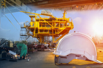 white hard safety helmet hat for safety project of workman as engineer or worker on construction site and rig background.