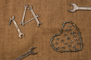 rusty keys and a heart shape. 14 february with tools. Screws and nuts