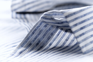 Close up of men's striped shirt. Cotton fabric.