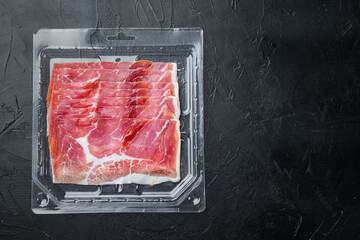 Gourmet, manually sliced jamon, on black background, flat lay  with copy space for text