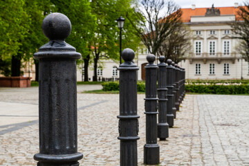 Black pillars on the sidewalk in the city..