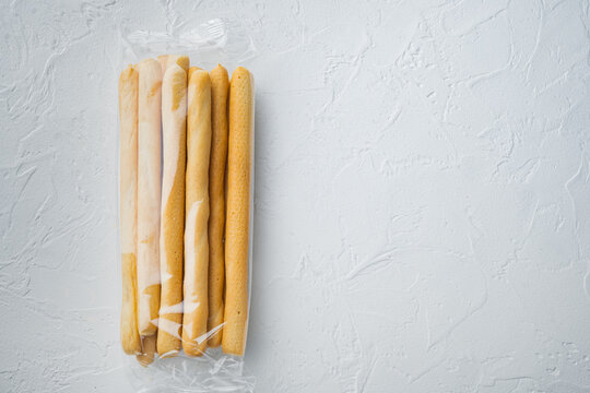 Breadsticks With Olive Oil, On White Background, Top View  With Copy Space For Text