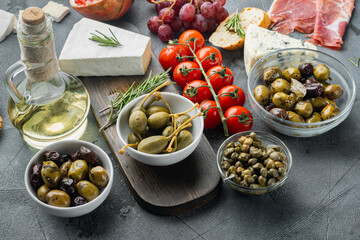 Mediterranean olives and capers, on gray background