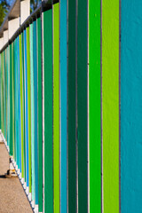 Colored fence in green, yellow and blue..