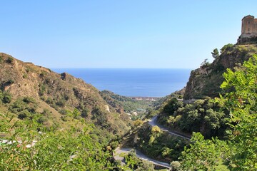serpentines in the hills, the road between the hills, between the sea view, a small town in Sicily, the road to Savoca