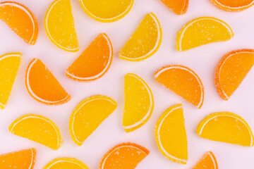 
Background of gummy candies in the form of orange and lemon slices.