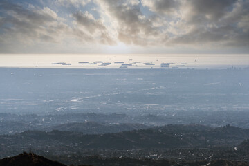 Aerial view towards ships waiting off the coast of Los Angeles and Long Beach California.